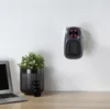 A wall heater is mounted on a white wall above a desk with a laptop, a plant in a pot, and a remote control. Anteprima dell’immagine prodotto