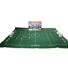 A Subbuteo Champions League Edition table football game set up on a green pitch with players and goals. Produktbild-Vorschau