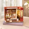 A miniature dollhouse bakery display on a book. Anteprima dell’immagine prodotto