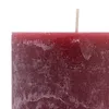 A close-up view of the top portion of a rustic, burgundy-colored pillar candle with a visible wick. Anteprima dell’immagine prodotto
