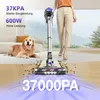 A person is using a cordless vacuum cleaner in a living room with a dog present. The vacuum is cleaning up debris from the floor, and there are graphics indicating its power. Produktbild-Vorschau