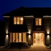 A brick house at night, illuminated by exterior lights. Náhled obrázku produktu