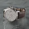 A close-up studio shot of a Festina chronograph watch with a brown leather strap, placed on a reflective gray surface. Podgląd zdjęcia produktu
