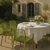 An outdoor dining setting with green chairs around a round table covered with a white tablecloth. Voir les images du produit