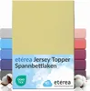 A stack of folded fitted sheets in various colors, with a large yellow sheet prominently displayed in the front. Produktbild-Vorschau