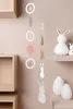 Easter decorations hanging on a wall with shelves and decorative eggs and bunnies. Produktbild-Vorschau