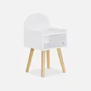A white bedside table with wooden legs against a white background.