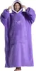 A woman wearing a purple oversized hoodie blanket. Produktbild-Vorschau
