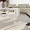 A modern living room with a white coffee table and a beige sofa. Podgląd zdjęcia produktu