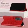 A red phone case with a floral design is shown in two configurations: one as a kickstand and the other closed. Produktbild-Vorschau