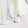 A close-up view of a folded sheer curtain with a green and white striped pattern. Produktbild-Vorschau