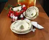 A festive Christmas-themed table setting with plates, bowls, and a gravy boat. Produktbild-Vorschau