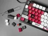 A close-up view of a gaming keyboard with some keycaps removed, showing the switches and a keycap puller. Produktbild-Vorschau