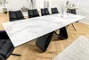 A dining table with chairs in a well-lit room. Produktbild-Vorschau