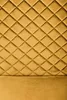 A close-up view of a mustard yellow quilted fabric, likely a headboard or upholstery. Produktbild-Vorschau