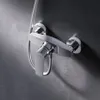 A close-up shot of a chrome shower faucet mounted on a textured gray wall. Produktbild-Vorschau