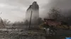 A dark, atmospheric scene with a ruined building and a winged creature in the foreground. Produktbild-Vorschau