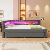 A modern grey daybed with LED lighting, decorated with pillows and a laptop, in a well-lit room. Produktbild-Vorschau