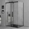 A modern bathroom with a black framed glass shower enclosure against a textured gray wall. Produktbild-Vorschau