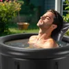 A man relaxing in an outdoor hot tub. Produktbild-Vorschau