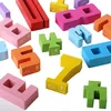 A collection of colorful wooden number blocks scattered on a white background. Produktbild-Vorschau