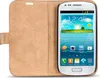 A white smartphone in a tan flip case, open to show the screen. Produktbild-Vorschau