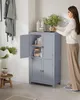 A woman is placing a plant into a gray bathroom cabinet. Produktbild-Vorschau