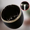 A black ceramic pot with a gold rim, shown from a slightly elevated angle. Náhľad obrázku produktu