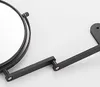 A close-up of a black wall-mounted makeup mirror with a telescopic arm. Produktbild-Vorschau