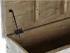 A close-up view of the inside of an open wooden chest, showing the hinge mechanism. Voir les images du produit
