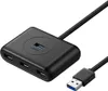 A black USB hub with multiple ports and a connected USB cable, shown against a white background. Náhľad obrázku produktu
