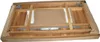 The underside of a wooden table, partially assembled and packed in a cardboard box. Produktbild-Vorschau