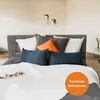 A bed with multiple pillows and a white duvet. Náhľad obrázku produktu