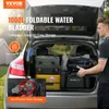 The back of a car is open, filled with camping gear, and a man is placing a folded water bladder into the trunk. Podgląd zdjęcia produktu
