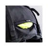 A close-up view of a black backpack with a small pocket containing a bright yellow item, possibly a rain cover. Anteprima dell’immagine prodotto