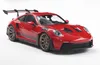 A red Porsche 911 GT3 RS model car is shown from a three-quarter front angle against a white background. Produktbild-Vorschau
