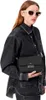 A woman wearing sunglasses and a denim jacket holds a black crossbody bag. Anteprima dell’immagine prodotto