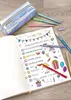 A notebook with a party checklist and glitter pens are laid out on a wooden surface. Podgląd zdjęcia produktu