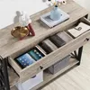 A close-up view of a console table with items inside its drawers and on its surface. Produktbild-Vorschau