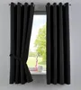 A black curtain is tied back with a tie-back, revealing a window with a view of trees and a vase on the windowsill. Produktbild-Vorschau