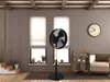 A living room with a fan, a clock, and a chair. Voir les images du produit