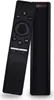 A black remote control is leaning against a black rectangular device, both on a white background. Náhled obrázku produktu
