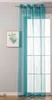 A sheer turquoise curtain hangs in front of a window with a framed picture of greenery on the wall. Produktbild-Vorschau