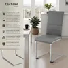 A modern dining room setting with a table and chairs. Voir les images du produit