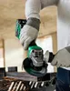 A person is using a cordless angle grinder to cut metal, with sparks flying. Produktbild-Vorschau