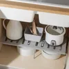 Kitchen cabinet interior with storage shelves and various kitchen items. Produktbild-Vorschau
