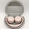 A pair of pink headphones is placed inside an open storage case. Produktbild-Vorschau
