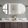 A modern bathroom vanity with a large oval mirror above it, featuring two sinks and faucets. Podgląd zdjęcia produktu