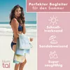 A woman on a beach holding towels, with marketing text and icons. Podgląd zdjęcia produktu