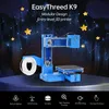A blue 3D printer is shown against a dark, starry background with yellow stars and constellation lines. Below the printer are icons representing its features. Produktbild-Vorschau